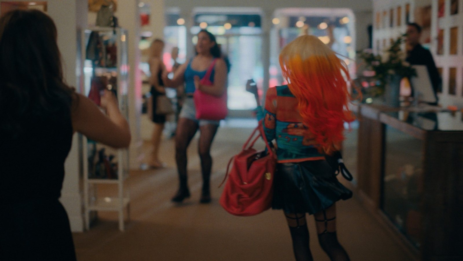 Rainbow Girls heist setup: propped pane of glass on C-stands in a consignment shop